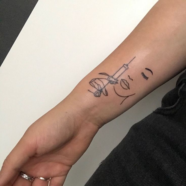 a person with a small tattoo on their arm