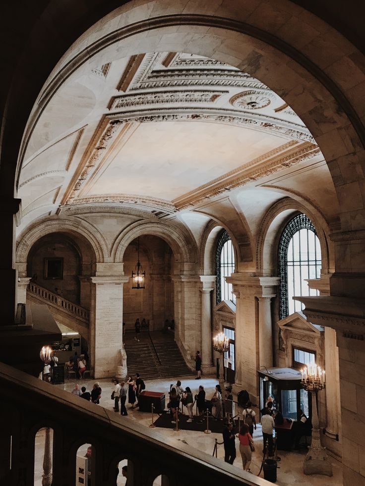 the inside of a train station with people walking around