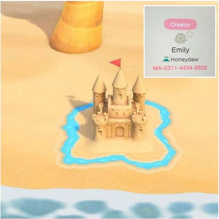 a sand castle sitting on top of a sandy beach