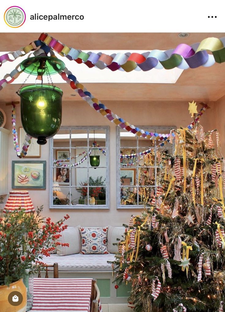 a decorated christmas tree sitting in the middle of a living room next to a window