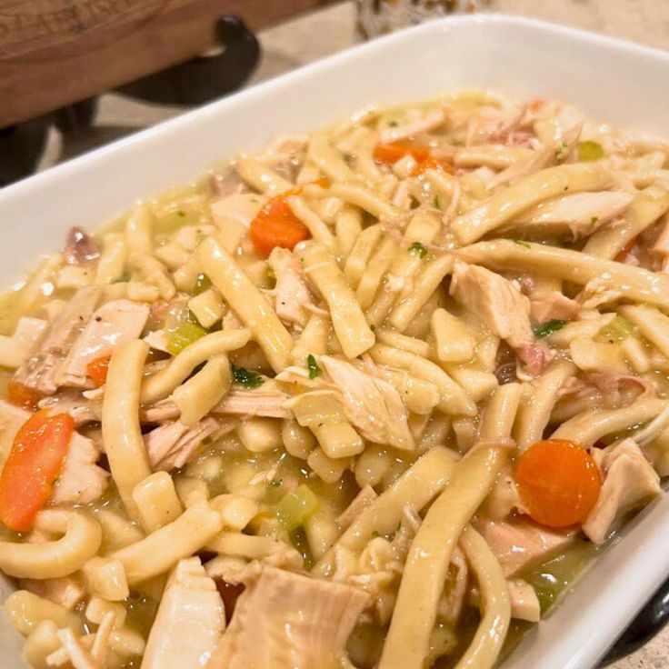 a white plate topped with pasta and chicken