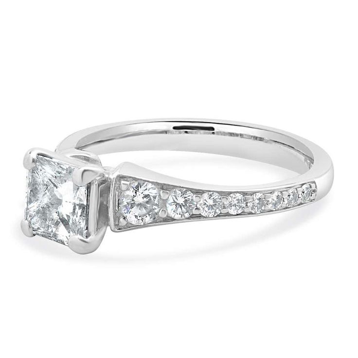 a princess cut diamond ring with channeled shoulders