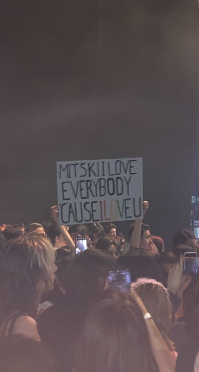 a group of people holding up signs in front of a crowd