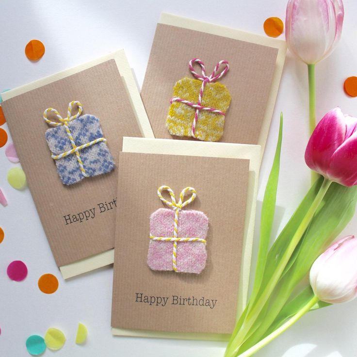 three birthday cards with presents on them and tulips in the foreground, surrounded by confetti