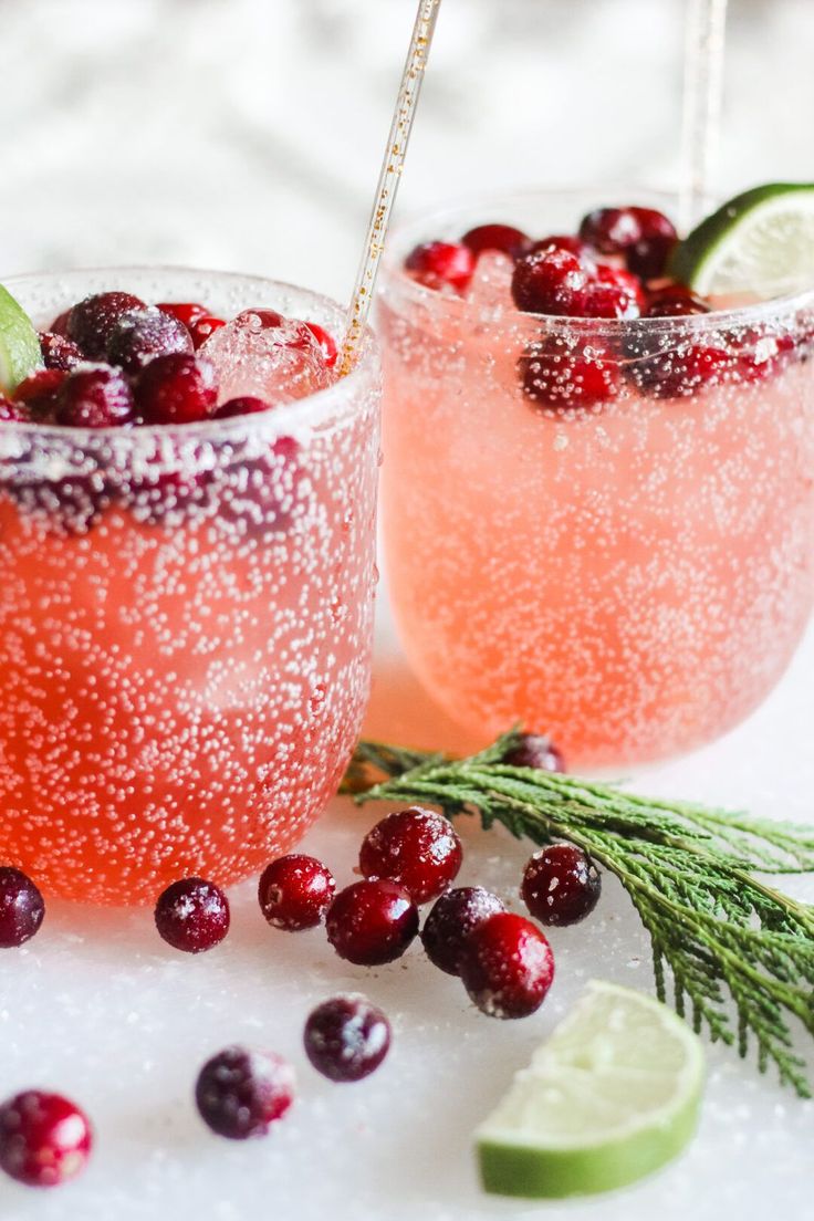 two glasses filled with cranberry lemonade and garnish