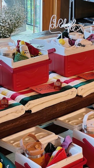 several red and white boxes filled with food on top of a table