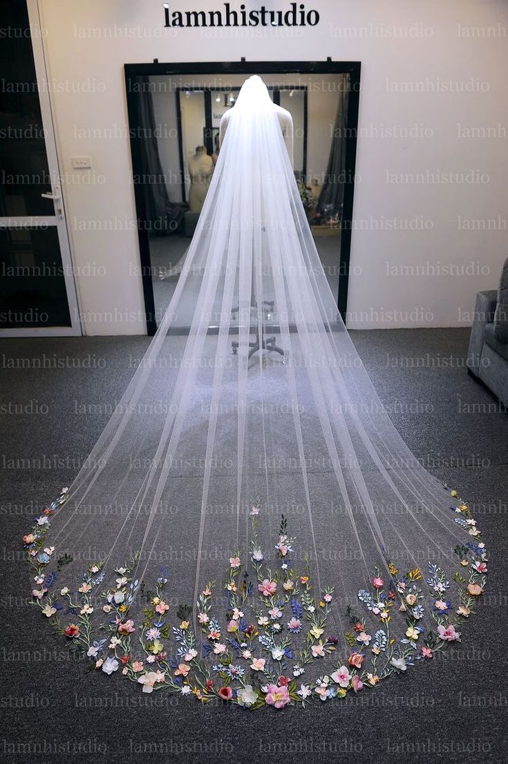 a wedding veil with flowers on the bottom