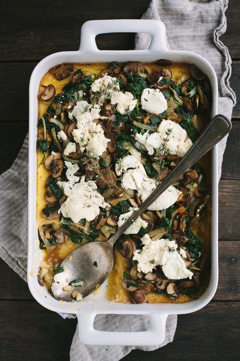 a casserole dish with mushrooms, cheese and spinach