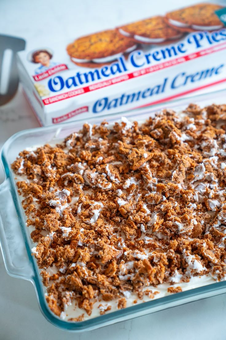 a glass baking dish filled with oatmeal creme next to a box of cookies