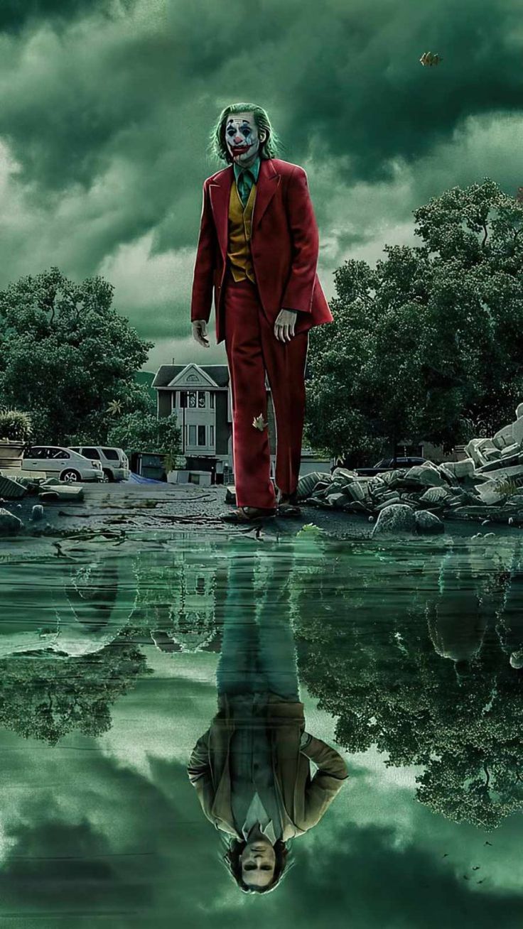 a man in a red suit standing on top of a body of water next to a house