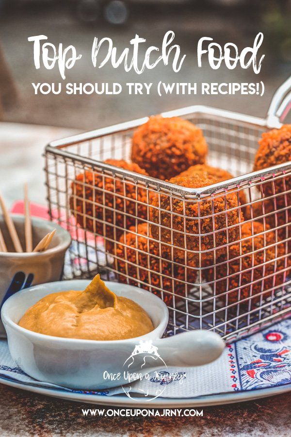 a basket filled with food sitting on top of a table next to a bowl of dip