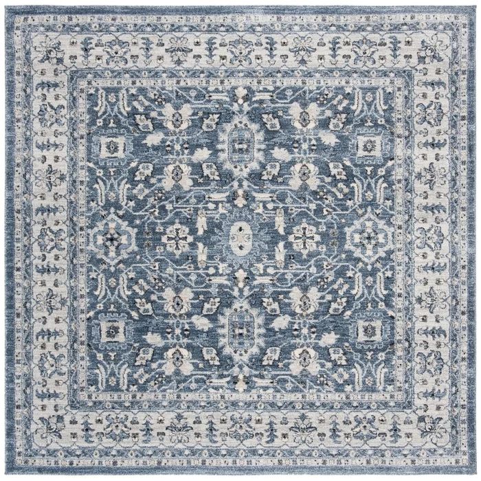 a blue and white rug with an ornate design on the middle, in front of a white background