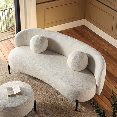 a white couch sitting on top of a wooden floor