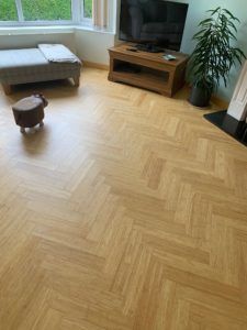 a living room with wood floors and a flat screen tv