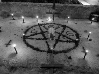 an image of a person standing in the middle of a circle with candles around it