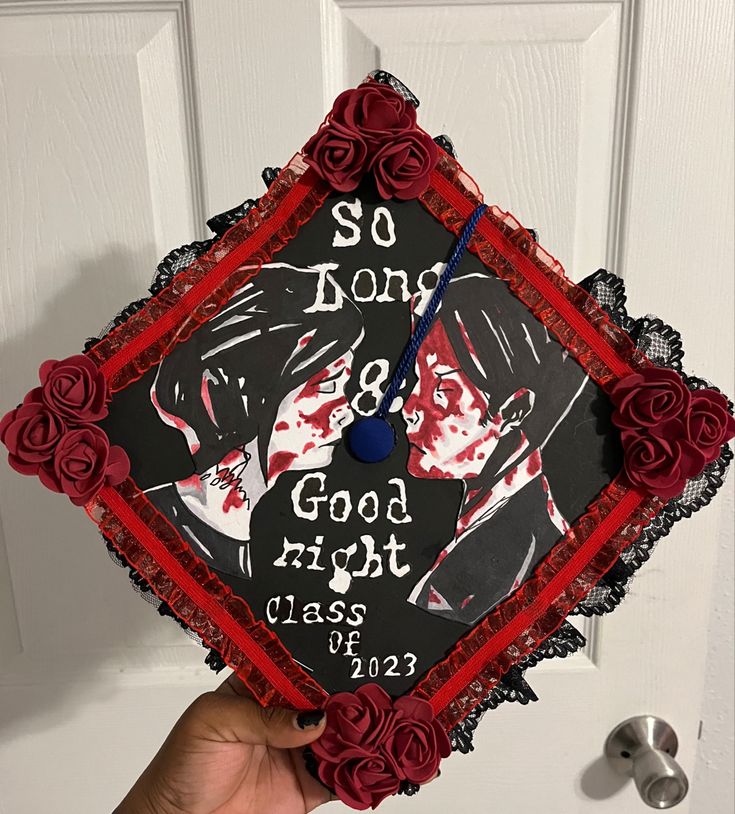 a hand holding a graduation cap decorated with roses and the words so don't & good night