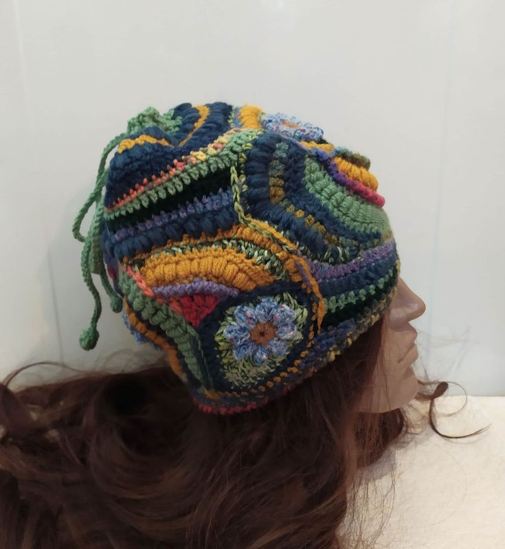 "A soft warm crochet  multicolor ( yellow, blue, green) Women  beanie hat  in boho style. This hat  made in a unique pattern that cannot be repeated exactly. Perhaps an approximate repetition.  This is a flight of fantasy and intuitive knitting. In this knitted set you will be unique, irresistible and delightful. This hat has no seam and you can turn it in any way and change your look.   This Beanie is sure to be the perfect accessory for your fall and winter wardrobe. It is stylish, functional, Handmade Yellow Crochet Hat For Winter, Yellow Crochet Cap Hat, Yellow Crochet Yarn Cap, Yellow Yarn Crochet Cap, Adjustable Multicolor Whimsical Crochet Hat, Green Adjustable Crochet Beanie, Multicolor Crochet Beanie Hat, Yellow Hand Knitted Beanie Crochet Hat, Yellow Yarn Crochet Hat