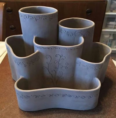 four blue vases sitting on top of a counter