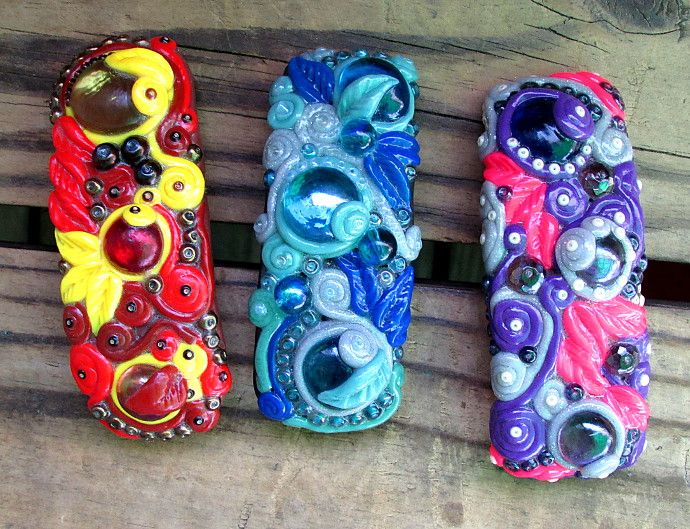 four colorful bracelets sitting on top of a wooden bench