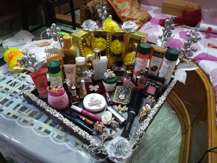 a table topped with lots of different types of beauty products on top of a table