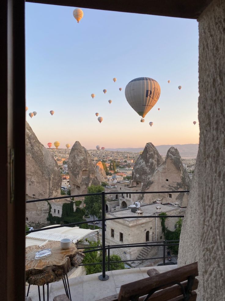 hot air balloons are flying over the city