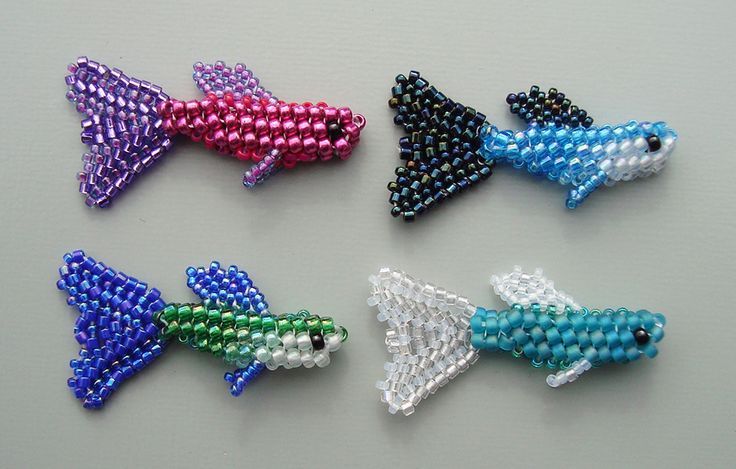 four different types of beaded fish on a table