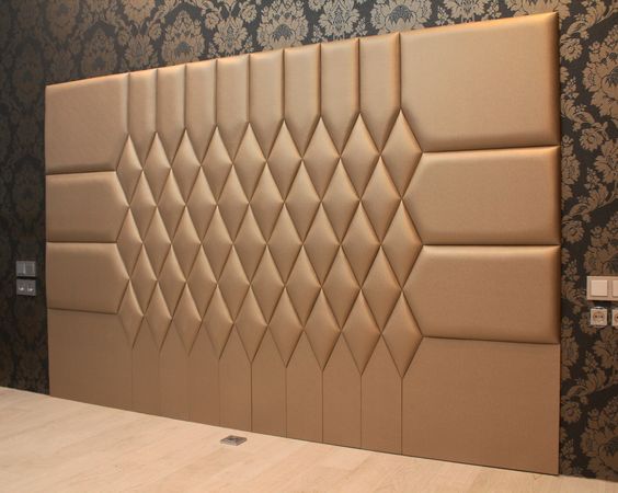 a room with a large wall made out of different shapes and sizes on the walls