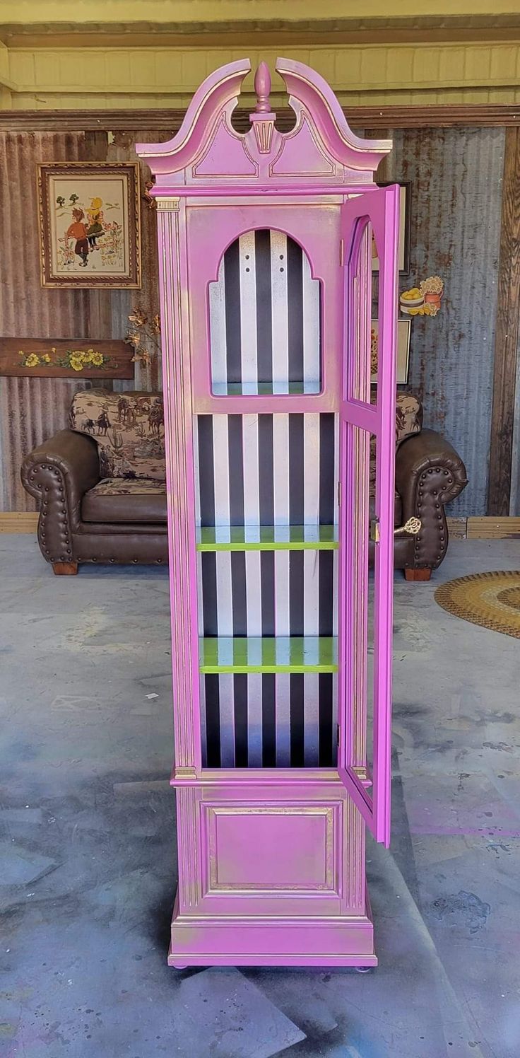 a pink china cabinet sitting on top of a floor