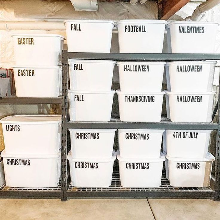 several white plastic buckets stacked on top of each other in a storage area with christmas decorations