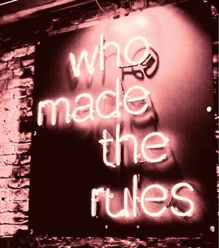 a neon sign that says who made the rules?