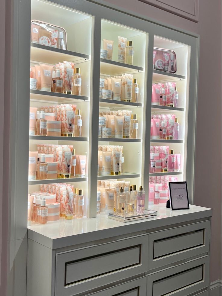 the counter is filled with many different types of cosmetics and personal care products in glass cases