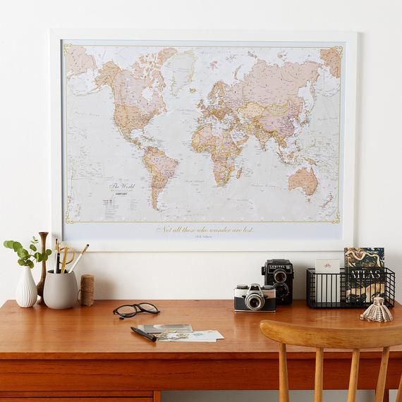 a wooden desk with a map on the wall above it