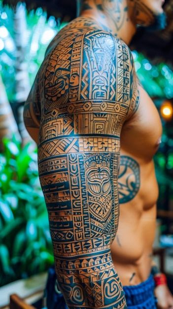 a man with tattoos on his arm and chest