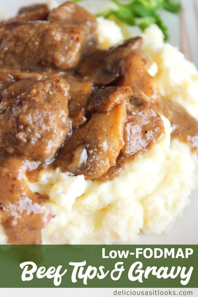 beef tips and gravy on top of mashed potatoes