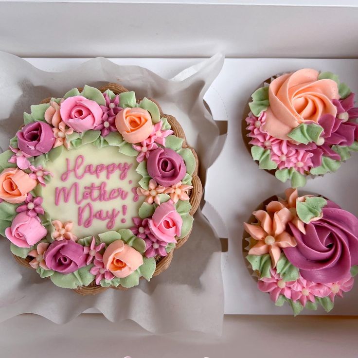 three decorated cupcakes in a box with the words happy mother's day written on them