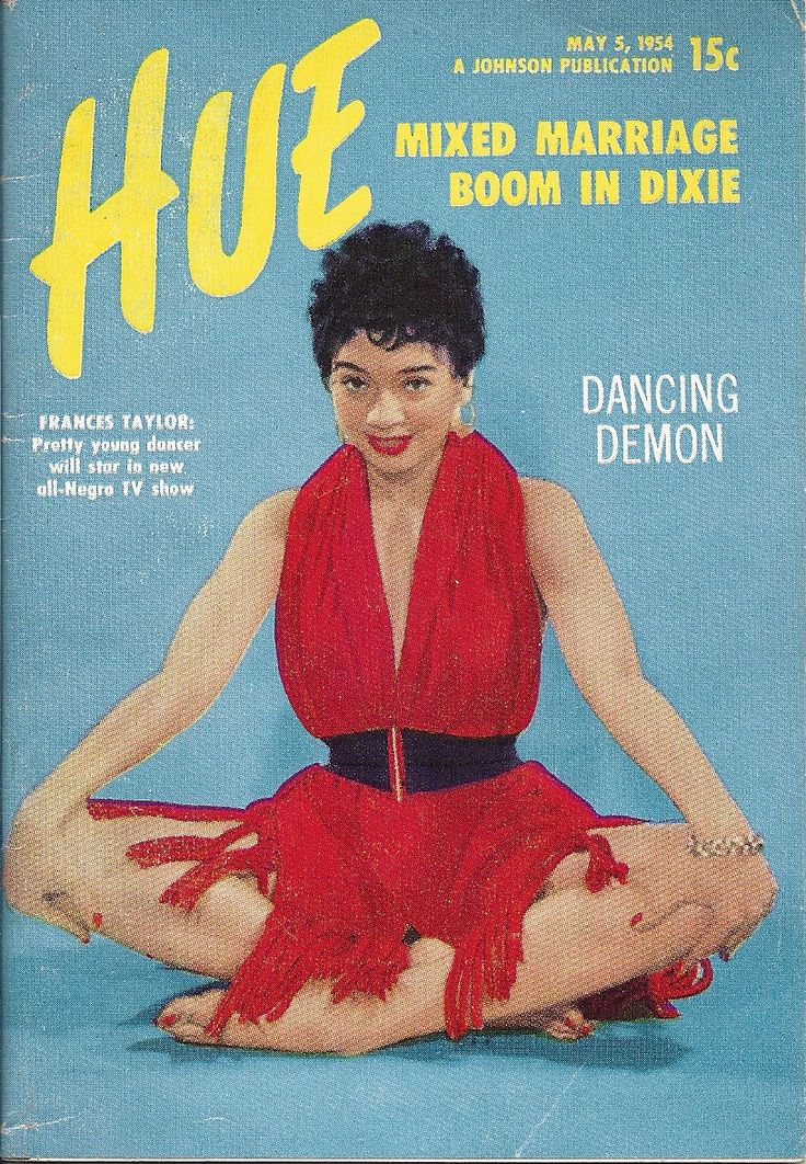 a magazine cover with a woman in a red dress sitting on the floor and smiling