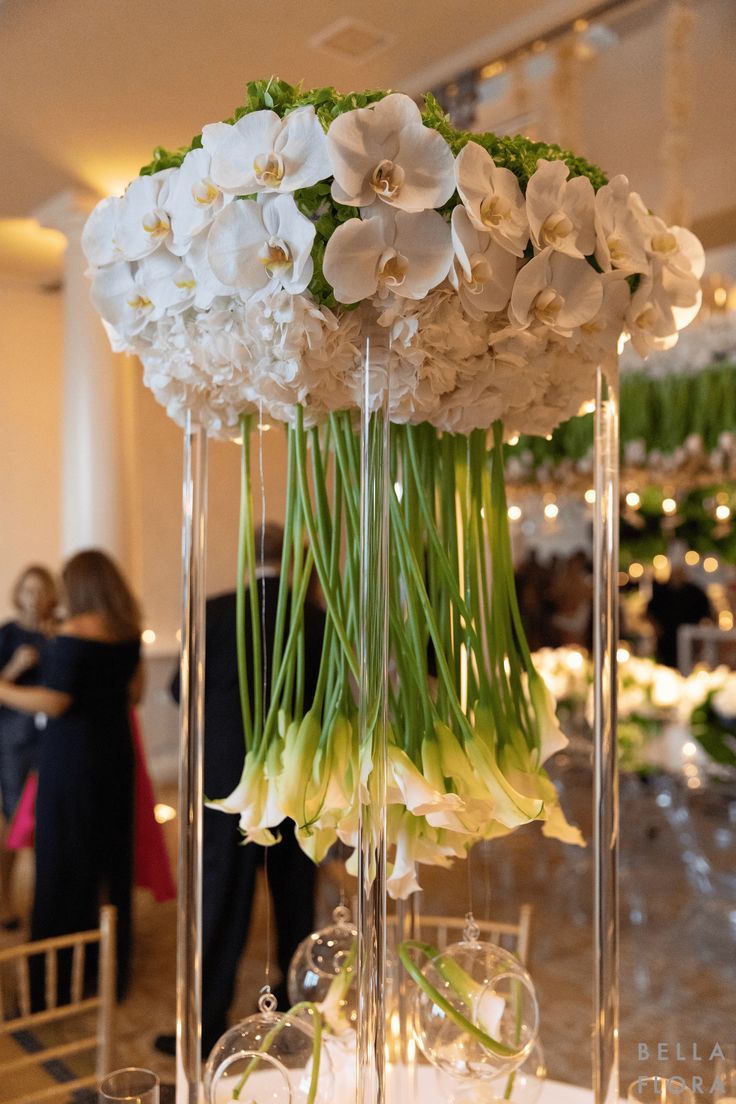 calla lillies
orchids
hydrangeas
modern
wedding
florals
centerpiece
unique florals Modern Wedding Flowers Arrangements, Calla Lillies Wedding, Tall Flower Centerpieces, Wedding Table Centerpieces Elegant, Orchid Centerpieces Wedding, White Hydrangea Centerpieces, Luxury Wedding Centerpieces, Modern Wedding Centerpieces, Table Centerpiece Wedding