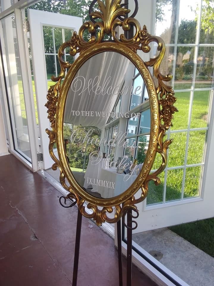 a mirror that is sitting on top of a stand in front of a window with the words welcome to the winery