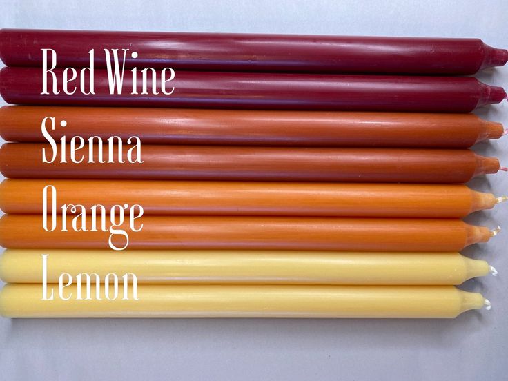 six orange and yellow candles are lined up in a row with the words red wine, sienna, orange lemon