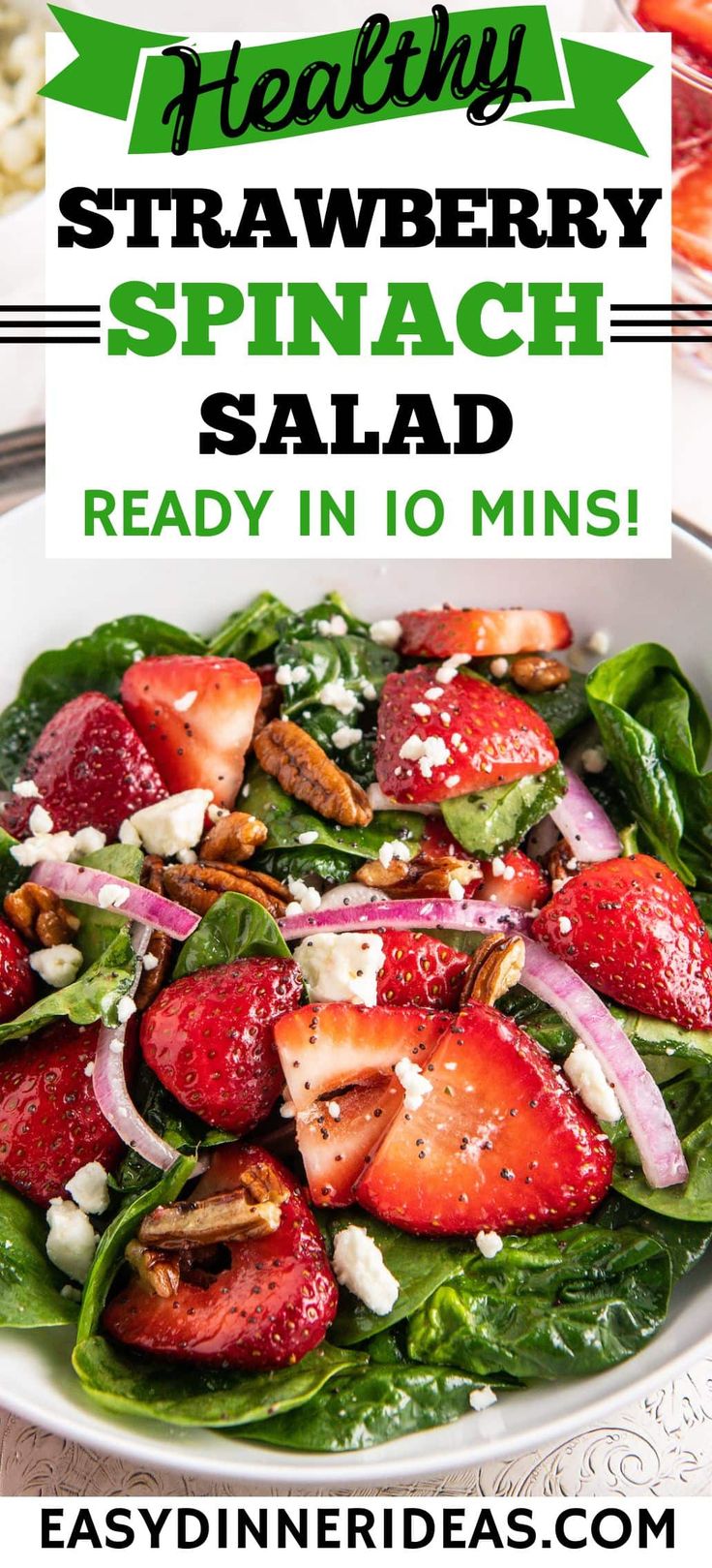 strawberry spinach salad in a white bowl with text overlay