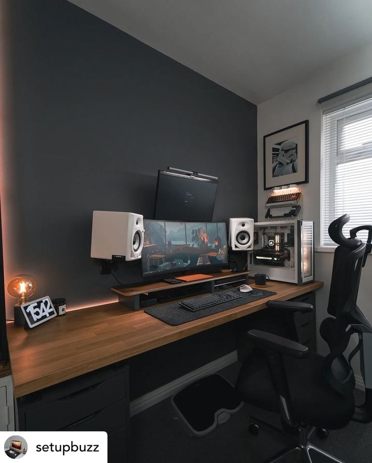 a computer desk with speakers on top of it