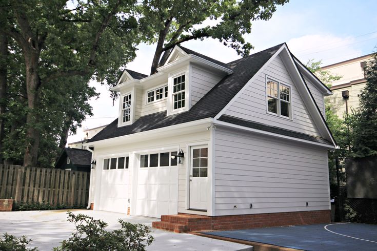 a white house with black roof and windows