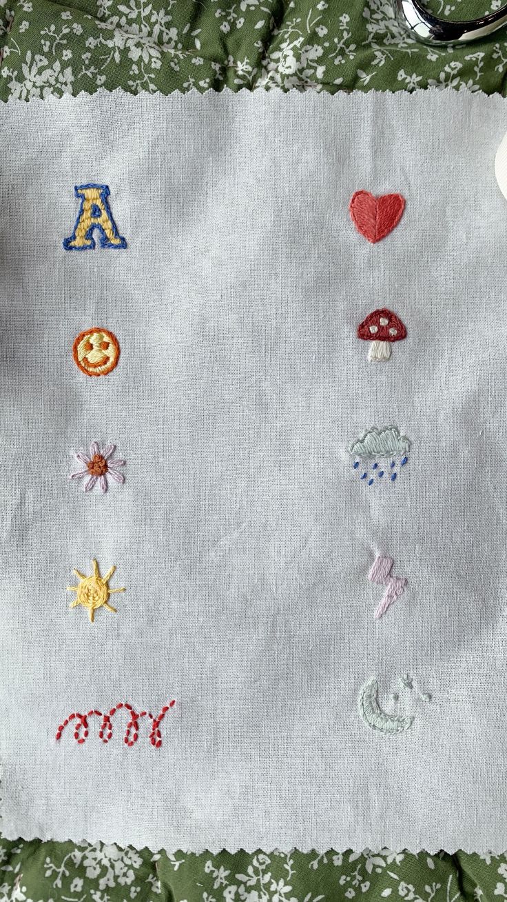 a table cloth with various embroidered designs on it