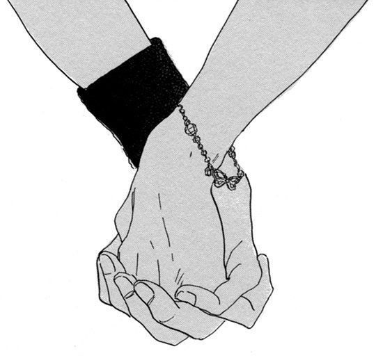 two people holding hands while wearing bracelets