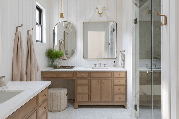 a bathroom with white walls and wooden cabinets