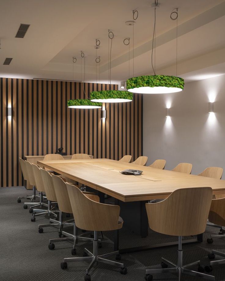 an empty conference room with wooden tables and chairs