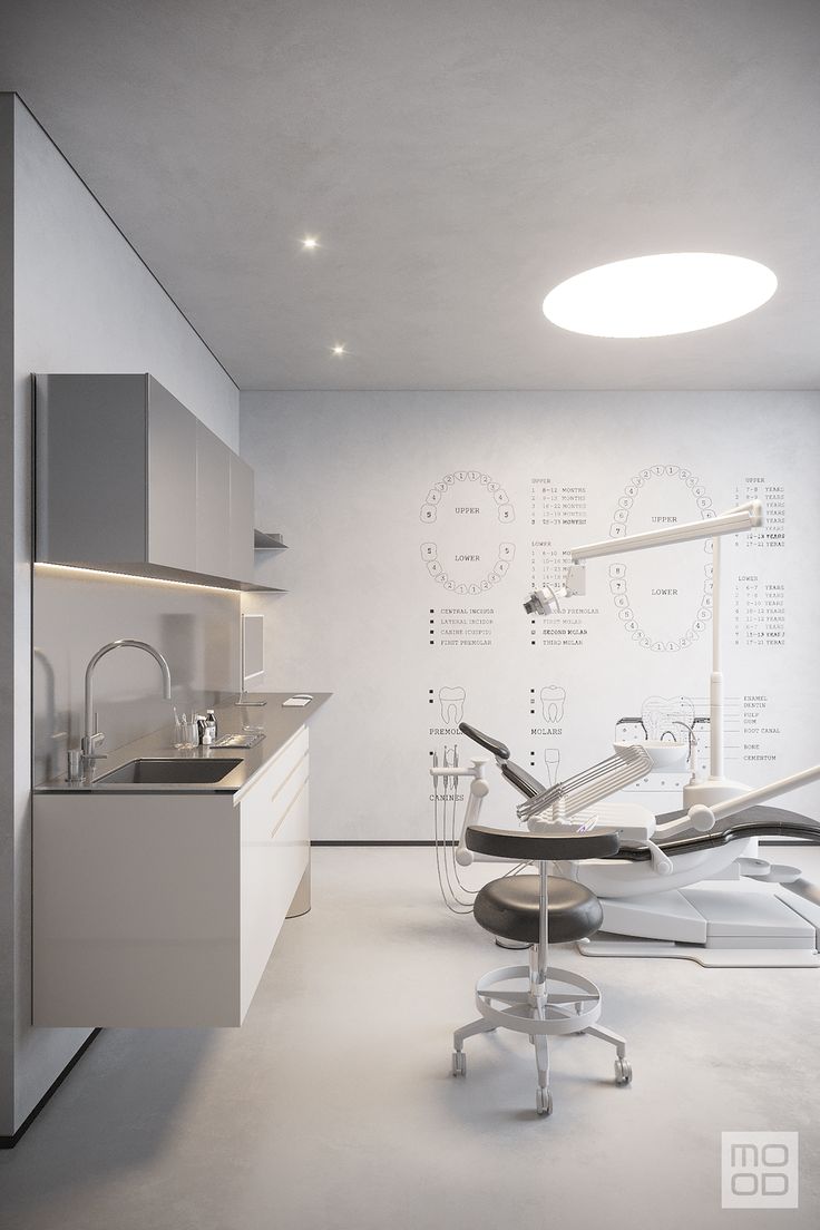 a dentist chair sitting in the middle of a room with white walls and flooring