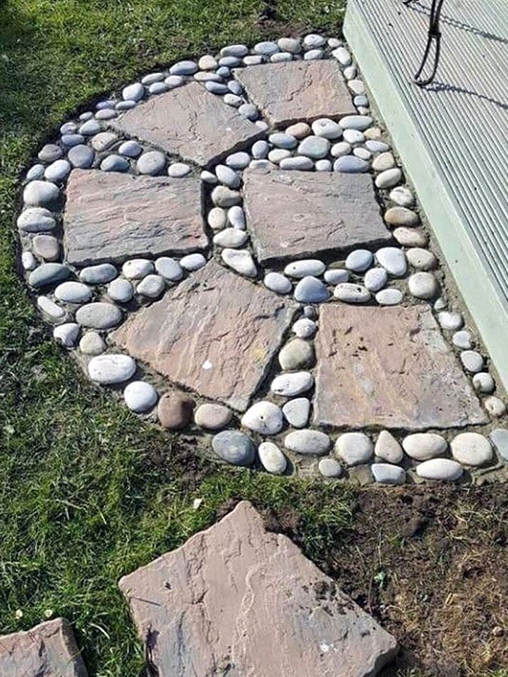 some rocks are arranged in the shape of a heart on top of a stone path