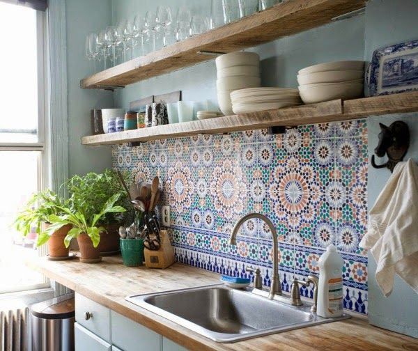 a kitchen with blue walls and wooden shelves