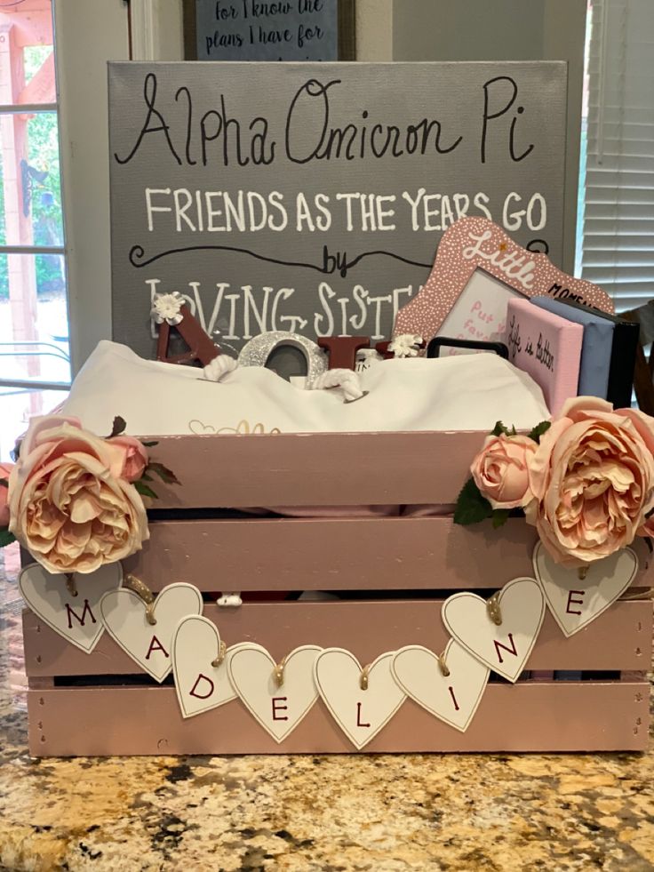 a wooden box filled with lots of valentine's day items on top of a counter